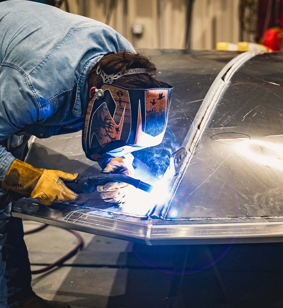 Diamondback craftsman hand-building a custom mud boat in the shop