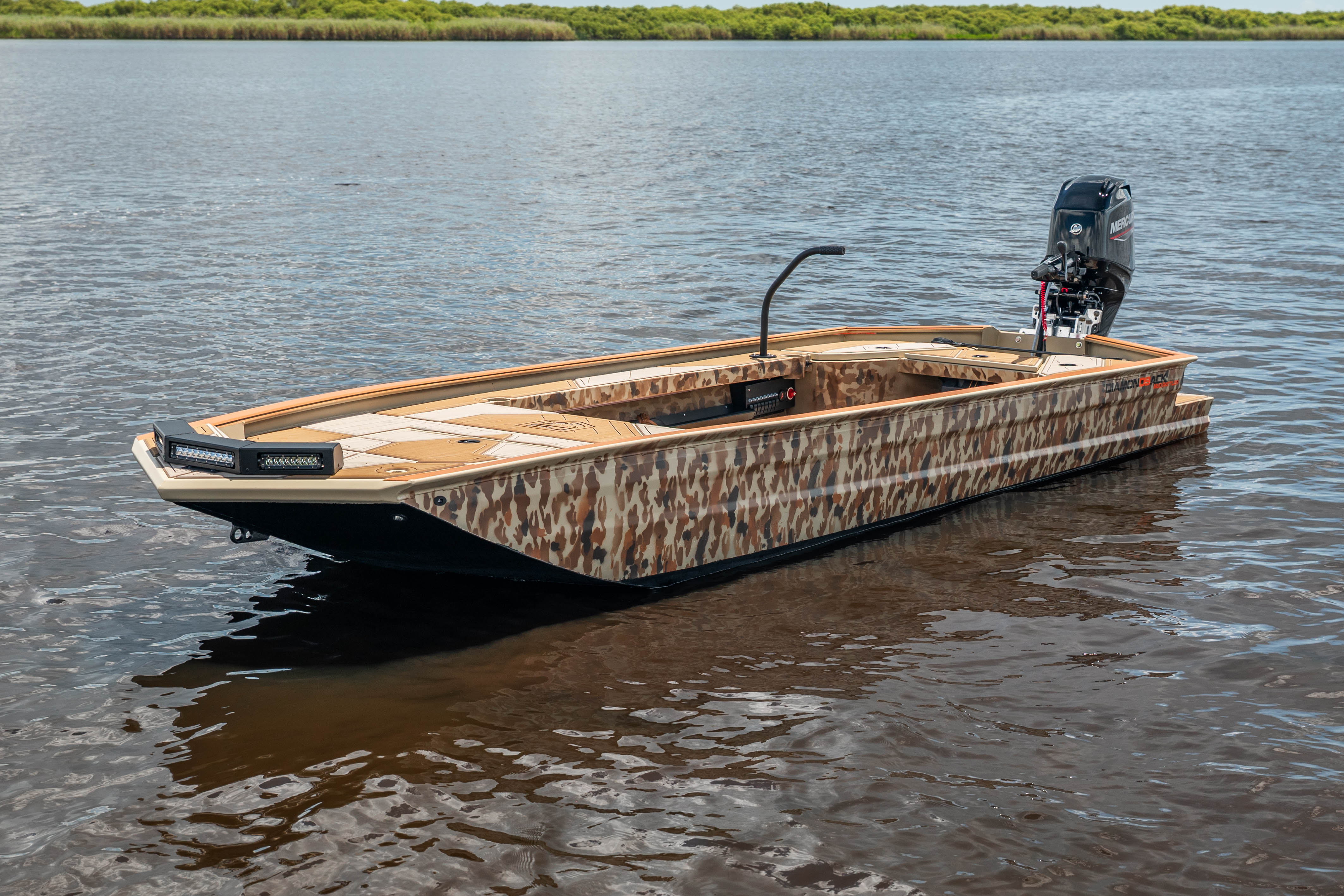 Camo Diamondback boat floating calmly on still water